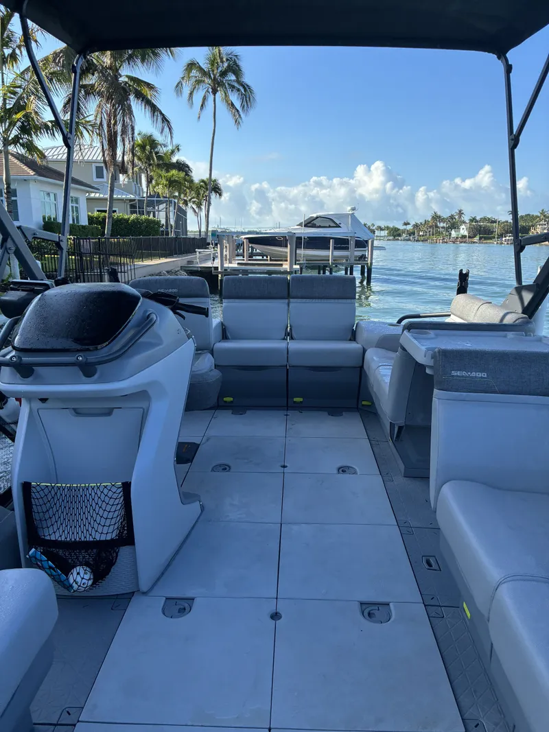 Slide: The Image of A Sea-Doo Switch boat docked in a calm residential area. - 10