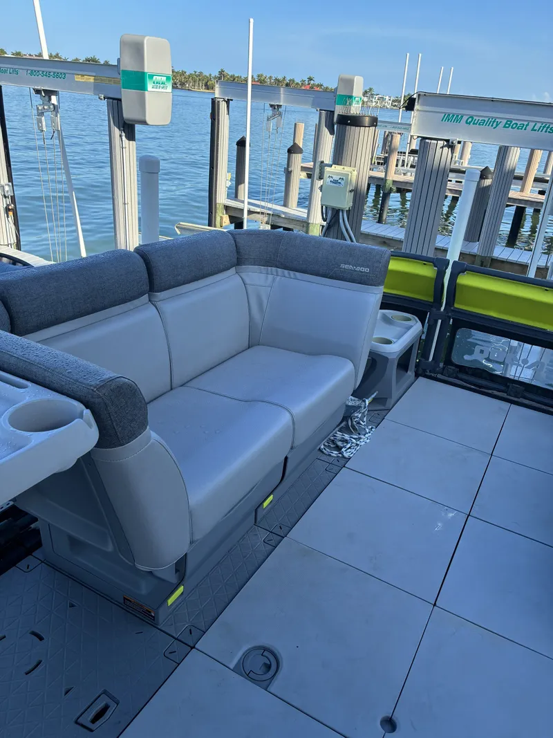 Slide: The Image of A modern boat with gray seating and an open deck, docked at a pier. - 11