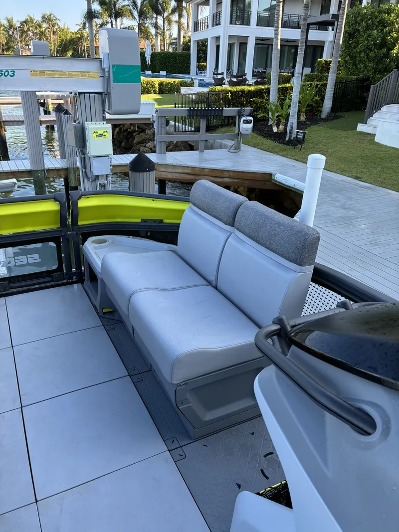 Slide: The Image of A modern boat with gray seating and sleek design, docked at a pier. - 12