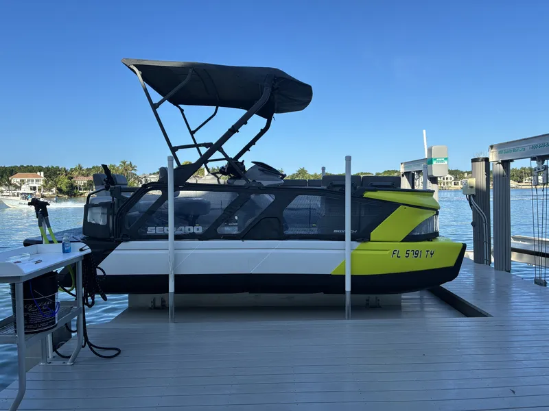 Slide: The Image of A Sea-Doo Switch boat is docked on a platform by the water. - 14