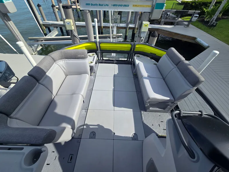 Slide: The Image of A modern boat with gray seating and an open deck, docked at a pier. - 2
