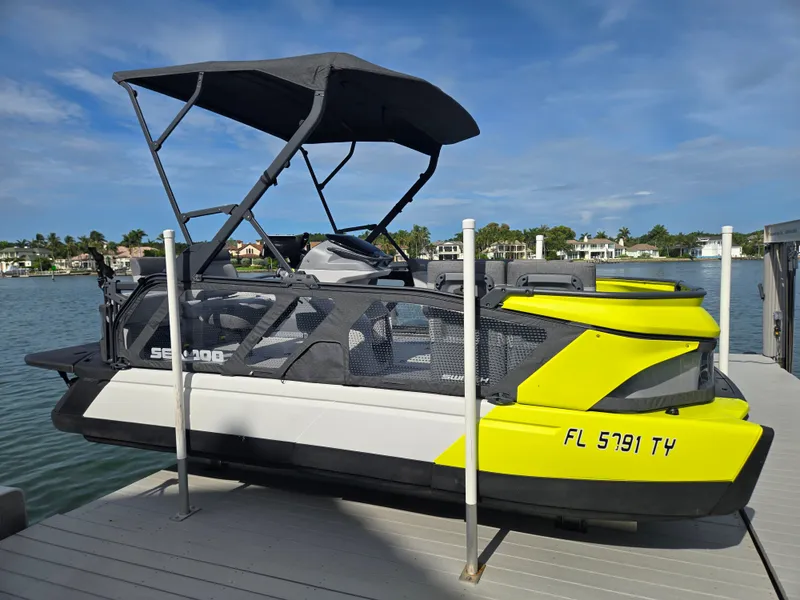 Slide: The Image of A 2024 Sea-Doo Switch is docked. It features a modern design with yellow accents. - 4