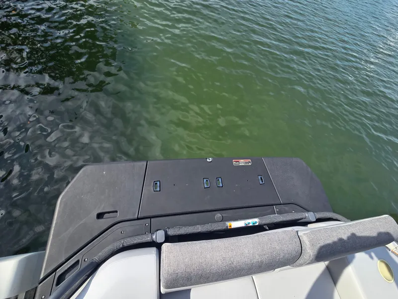 Slide: The Image of A Sea-Doo Switch boat on calm water, featuring a gray seat and black deck. - 8