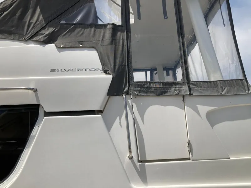 Slide: The Image of Close-up of a Silverton 322 Motor Yacht with a gray canopy. - 10