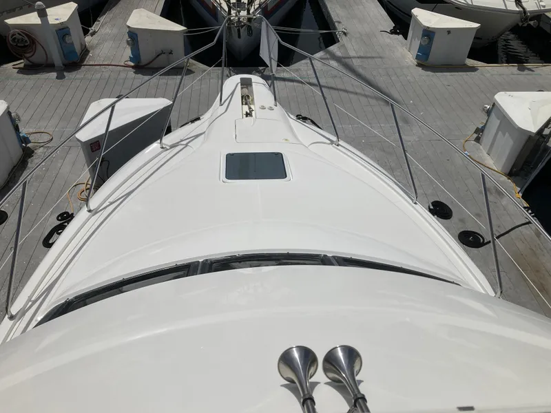 Slide: The Image of A white boat docked in a marina, surrounded by other boats. - 11