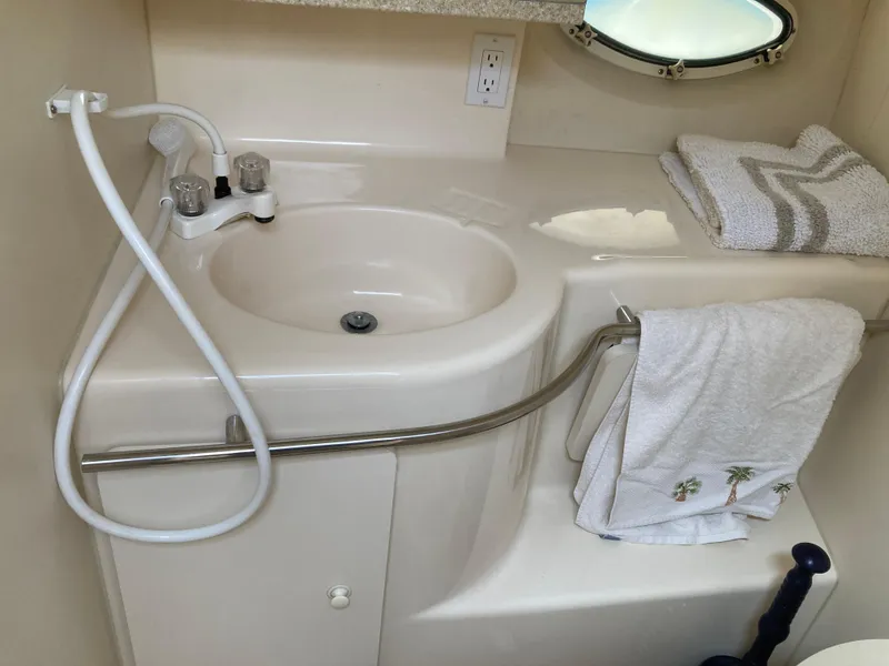 Slide: The Image of Interior view of a boat bathroom with sink, towels, and shower. - 13