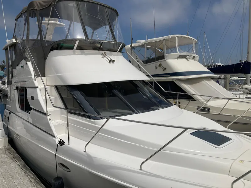Slide: The Image of A 1999 Silverton 322 Motor Yacht docked at the marina. - 2