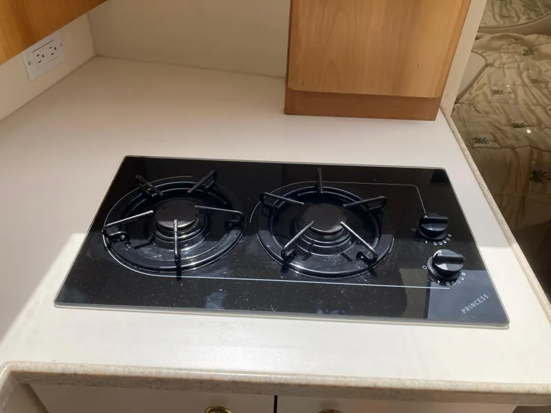 Slide: The Image of A two-burner cooktop in a boat's kitchen area. - 25