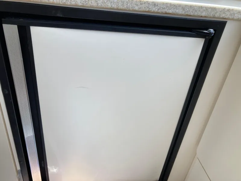 Slide: The Image of Interior view of a boat window with a black frame and white background. - 26