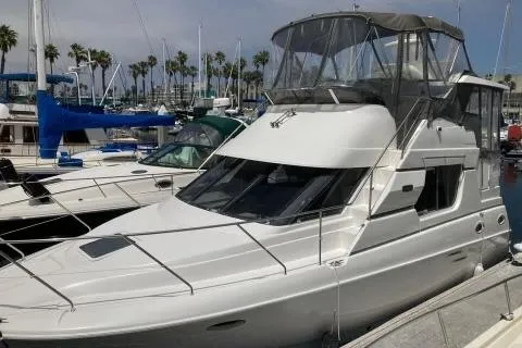 Slide: The Image of 1999 Silverton 322 Motor Yacht docked at a marina with other boats. - 37