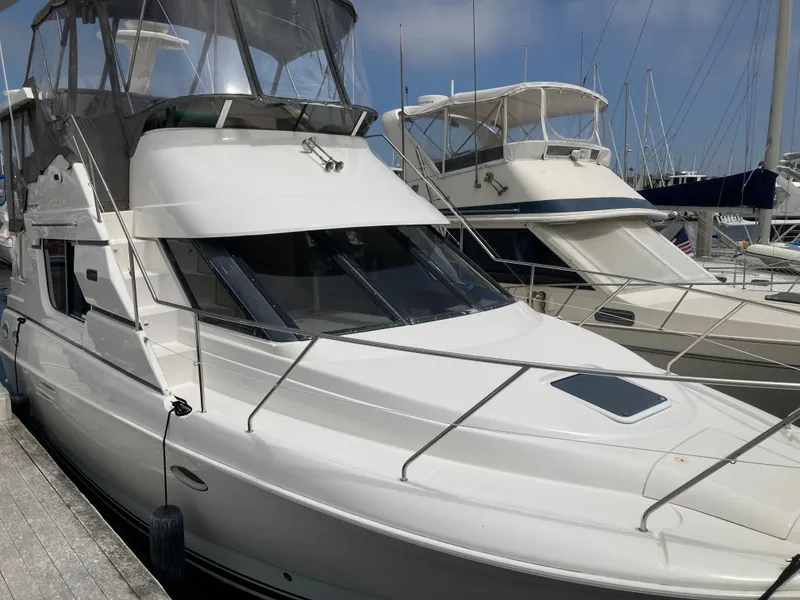 Slide: The Image of A 1999 Silverton 322 Motor Yacht docked at the marina. - 3