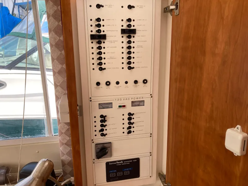 Slide: The Image of A control panel with numerous switches and knobs on a yacht. - 31