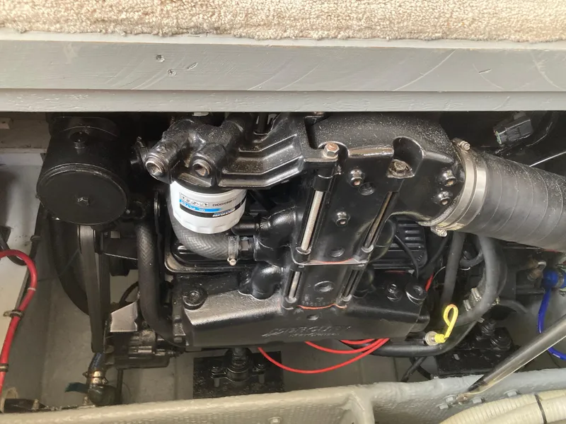 Slide: The Image of Engine compartment of a 1999 Silverton 322 Motor Yacht with visible hoses and cables. - 32