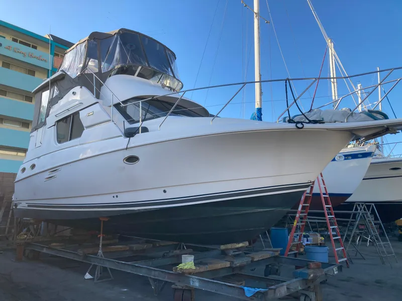 Slide: The Image of A 1999 Silverton 322 Motor Yacht is on a dry dock. - 6