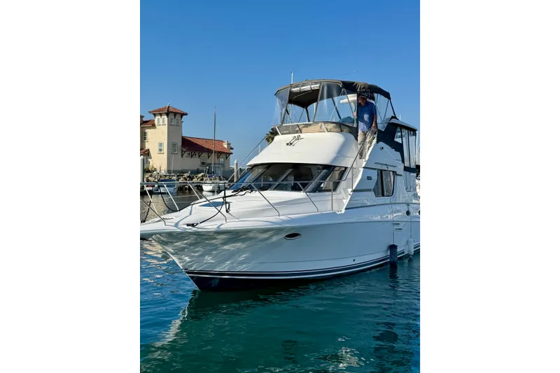 Slide: The Image of 1999 Silverton 322 Motor Yacht docked in a marina, clear blue sky background. - 39