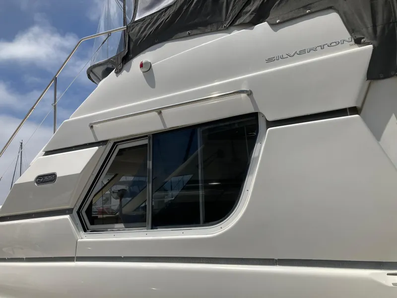 Slide: The Image of Close-up of a white yacht with windows and a black roof. - 9