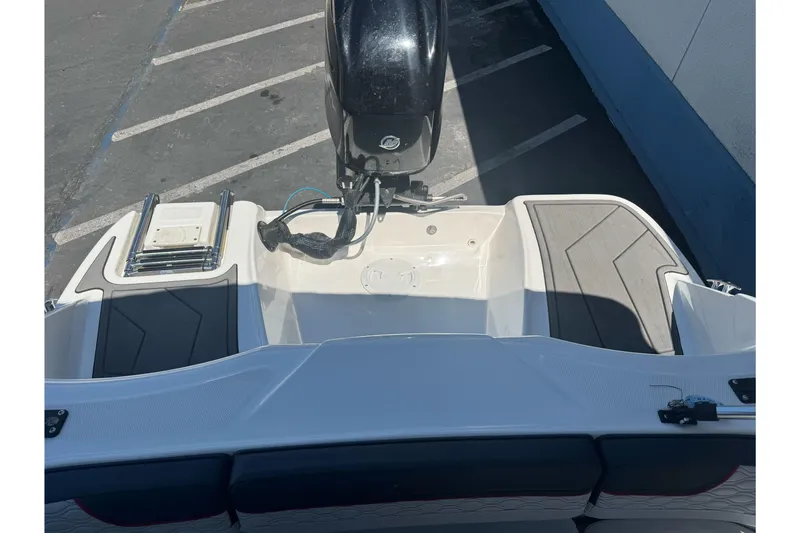 Slide: The Image of 2023 Bayliner Element M15 boat stern view with outboard motor and swim platform. - 15