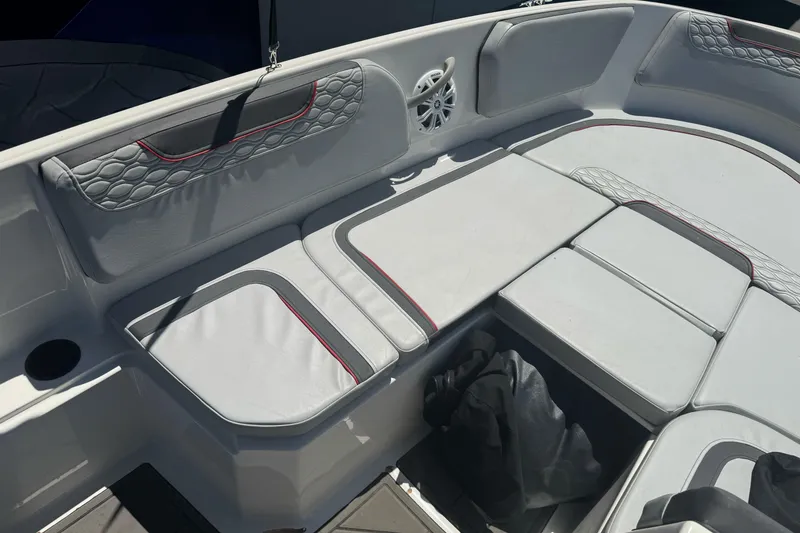 Slide: The Image of 2023 Bayliner Element M15 boat interior with cushioned seating and speaker. - 16