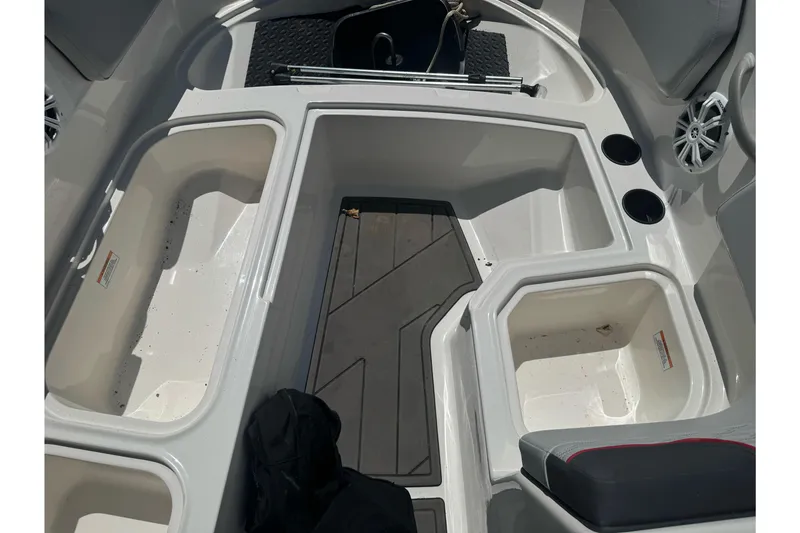 Slide: The Image of Interior view of 2023 Bayliner Element M15 boat, featuring storage compartments and cup holders. - 19