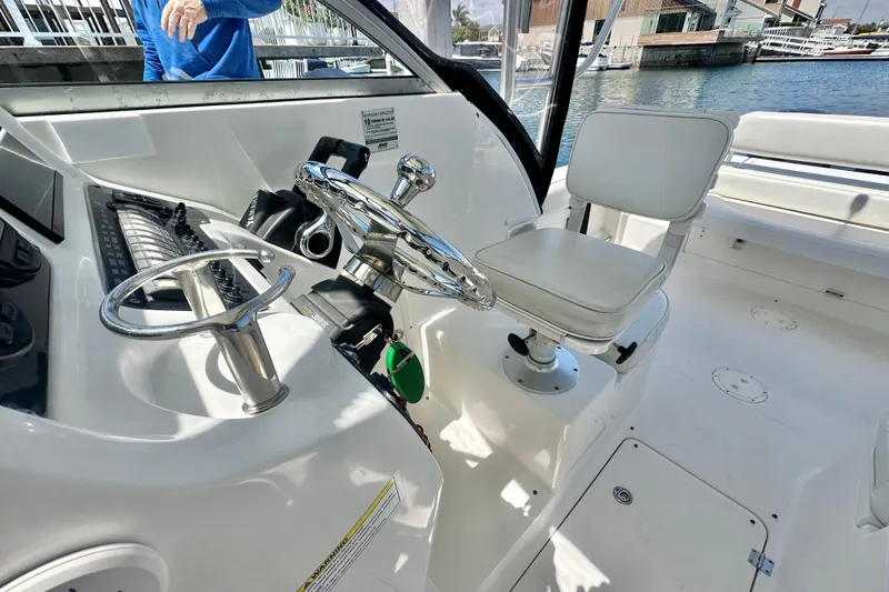 Slide: The Image of 2006 Robalo R245 Walkaround boat interior with steering wheel and seating. - 16