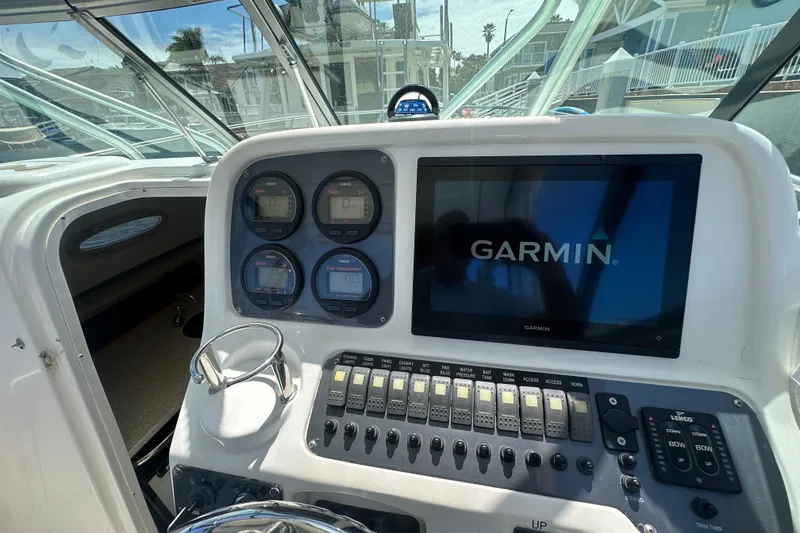 Slide: The Image of 2006 Robalo R245 Walkaround helm with Garmin display and control panel. - 17