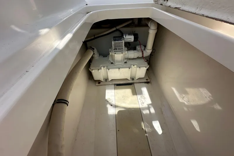 Slide: The Image of 2006 Robalo R245 Walkaround bilge area with pump and piping system. - 22