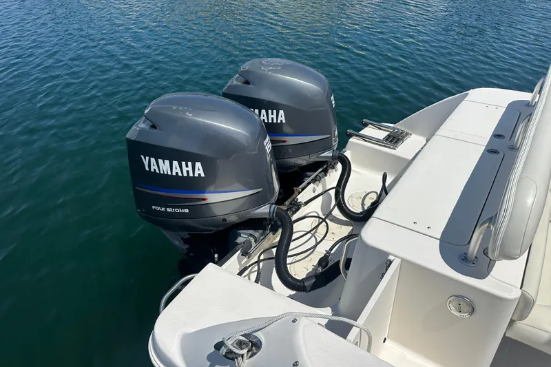 Slide: The Image of 2006 Robalo R245 Walkaround with twin Yamaha outboard engines on calm water. - 23