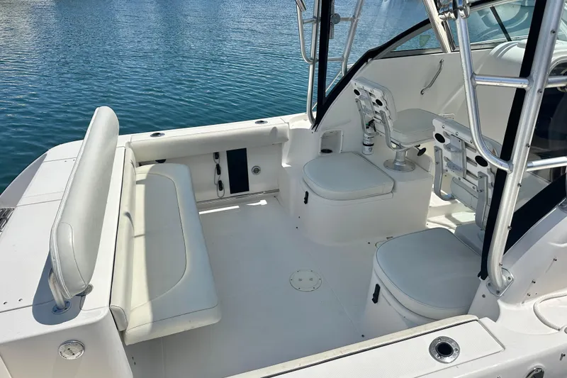 Slide: The Image of 2006 Robalo R245 Walkaround boat interior with seating, on calm water. - 24