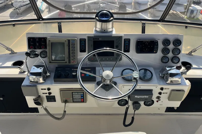 Slide: The Image of Helm of 1989 Ocean Alexander 440 Sundeck CPMY with navigation instruments and steering wheel. - 1