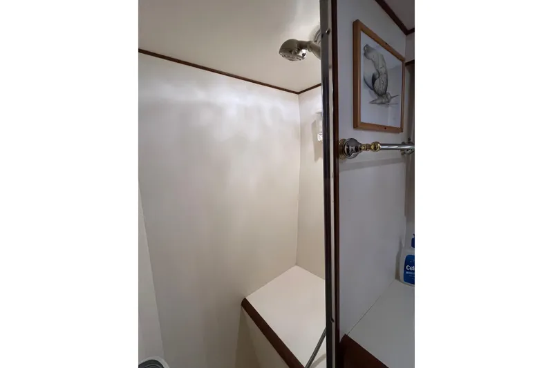 Slide: The Image of Shower area in 1989 Ocean Alexander 440 Sundeck CPMY yacht, featuring elegant fixtures and artwork. - 18