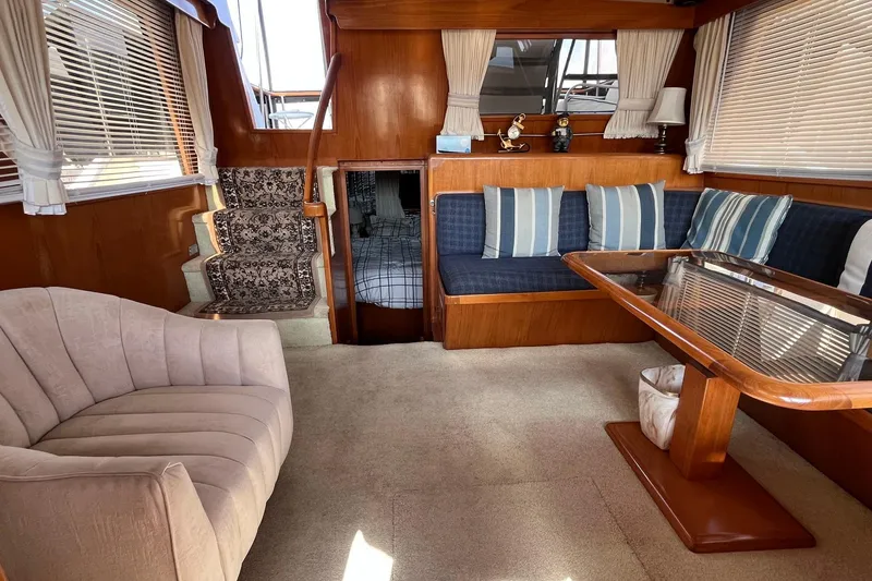 Slide: The Image of Interior of 1989 Ocean Alexander 440 Sundeck CPMY with plush seating and wooden accents. - 22
