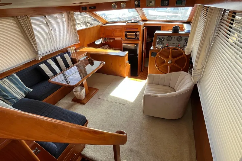 Slide: The Image of Luxurious interior of 1989 Ocean Alexander 440 Sundeck CPMY yacht with elegant seating and helm. - 23