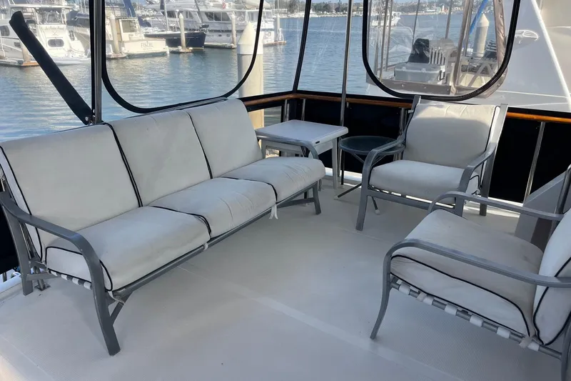 Slide: The Image of Spacious seating area on 1989 Ocean Alexander 440 Sundeck CPMY yacht, overlooking marina. - 25