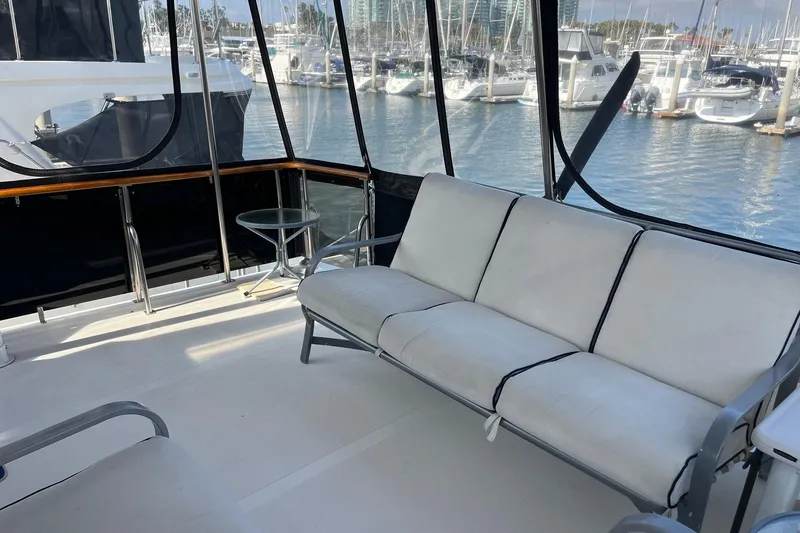 Slide: The Image of 1989 Ocean Alexander 440 Sundeck CPMY interior with white seating, marina view. - 26