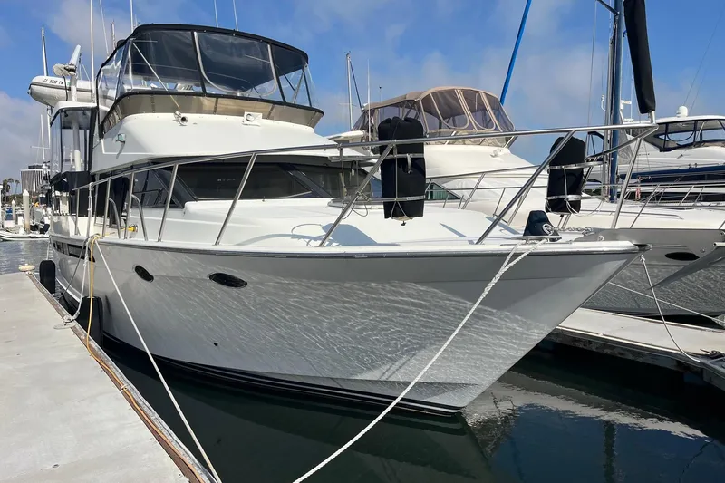 Slide: The Image of 1989 Ocean Alexander 440 Sundeck CPMY yacht docked at marina, sunny day. - 33