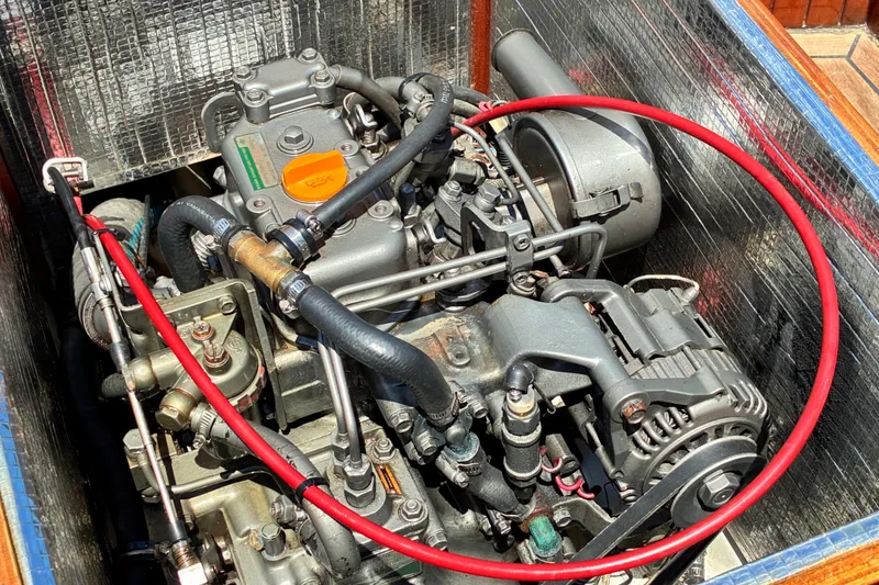 Slide: The Image of Engine of a 2003 Castine Harbor Launch with visible components and red hose. - 12