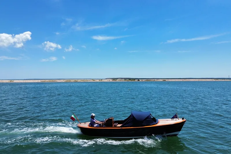 Slide: The Image of A 2003 Castine Harbor Launch boat cruising on a sunny day with clear blue skies. - 2