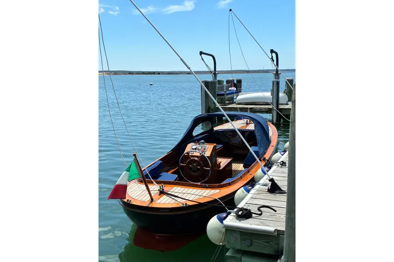 Slide: The Image of 2003 Castine Harbor Launch docked on calm water under a clear blue sky. - 24