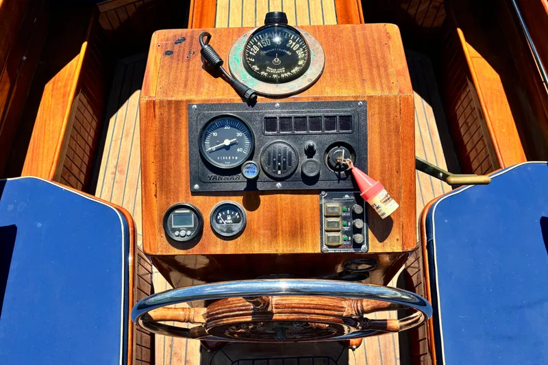 Slide: The Image of Steering console of a 2003 Castine Harbor Launch with wooden finish and nautical instruments. - 7
