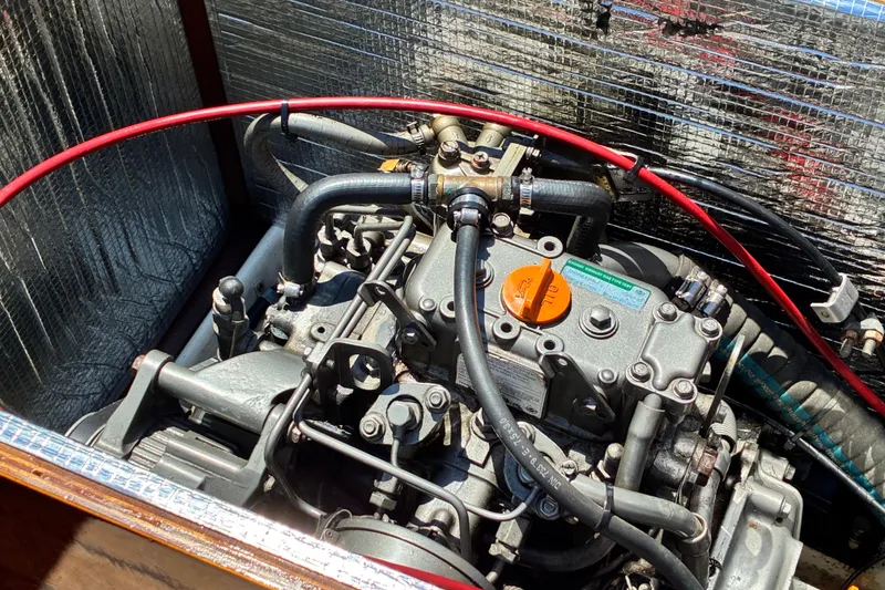 Slide: The Image of Engine of a 2003 Castine Harbor Launch boat, featuring hoses and metallic components. - 8