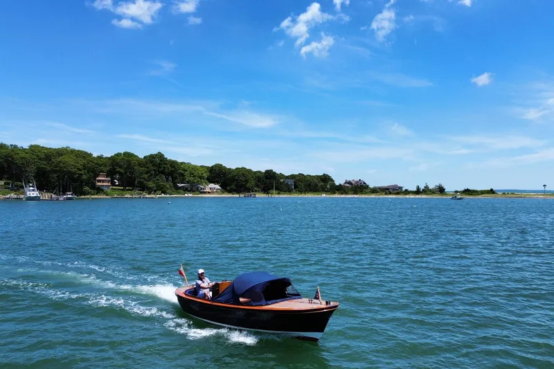 Slide: The Image of 2003 Castine Harbor Launch cruising on a sunny day near a scenic shoreline. - 13