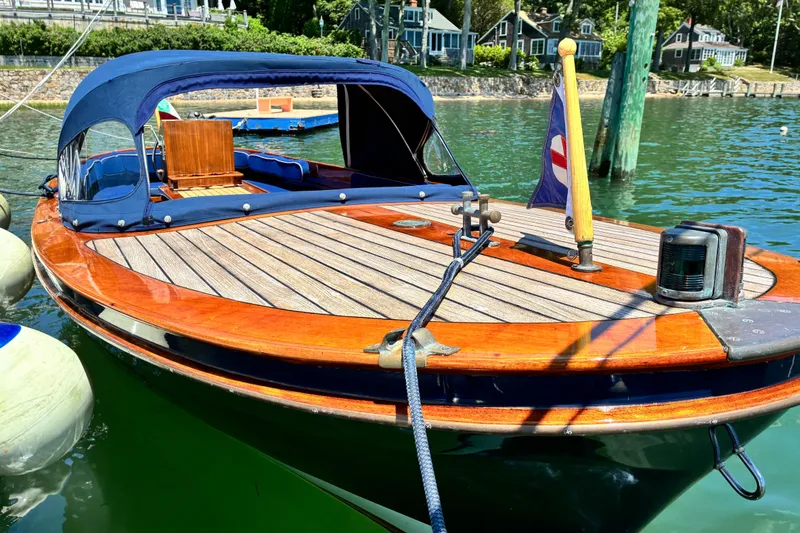 Slide: The Image of 2003 Castine Harbor Launch boat with wooden deck, docked in a scenic harbor setting. - 25