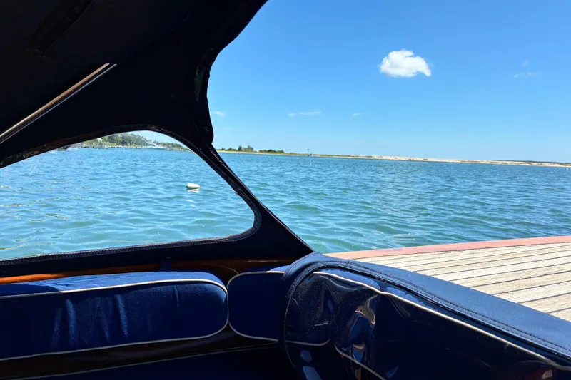 Slide: The Image of View from a 2003 Castine Harbor Launch boat, overlooking a serene blue lake. - 15