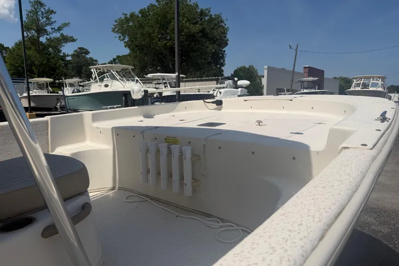 Slide: The Image of 2019 Carolina Skiff 218 DLV boat with spacious deck, docked outdoors. - 3