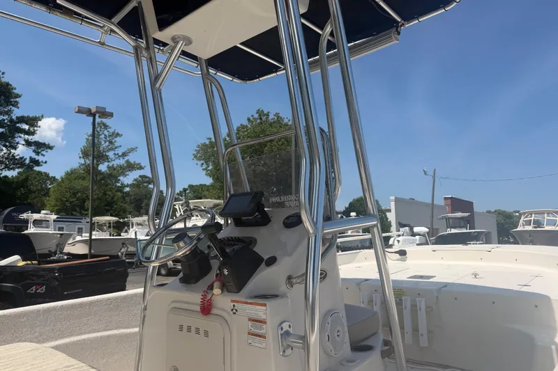 Slide: The Image of 2019 Carolina Skiff 218 DLV boat console with steering wheel and navigation equipment. - 4
