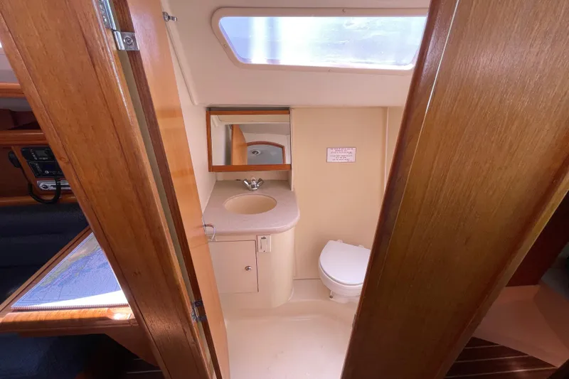 Slide: The Image of 2004 Hunter 33-2 yacht bathroom with sink, mirror, and toilet. - 18