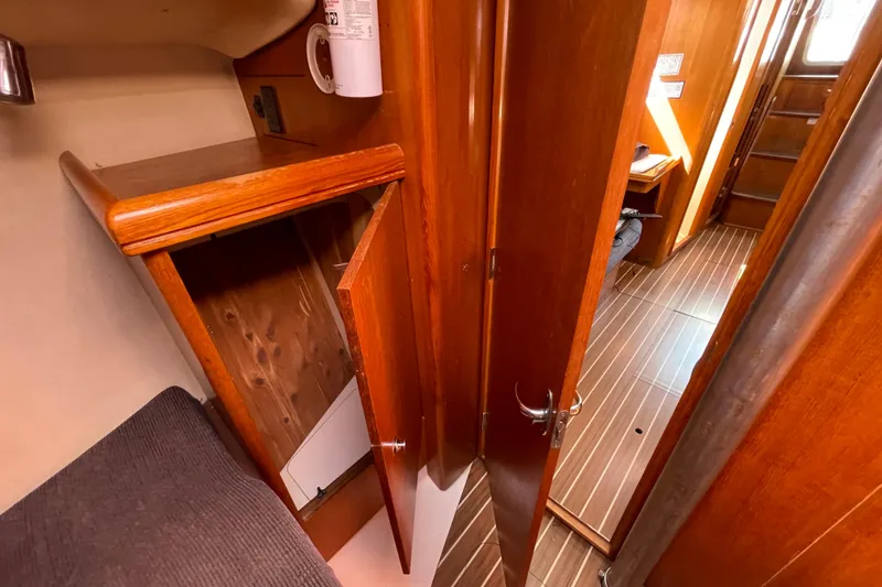 Slide: The Image of Interior of 2004 Hunter 33-2 sailboat with wooden cabinetry and flooring. - 22