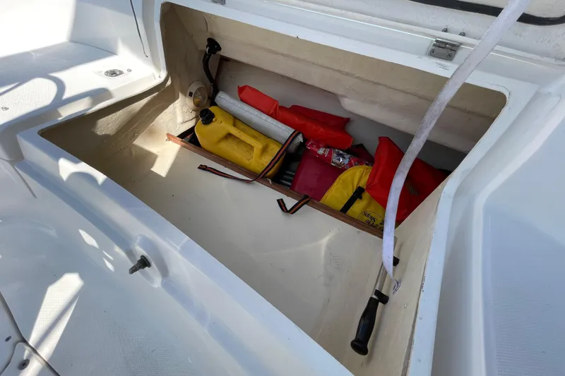 Slide: The Image of Storage compartment of a 2004 Hunter 33-2 boat with safety gear and equipment. - 28