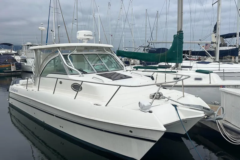 The Image of 2013 Glacier Bay 2680 Coastal Runner boat docked in a marina, surrounded by sailboats. - 0