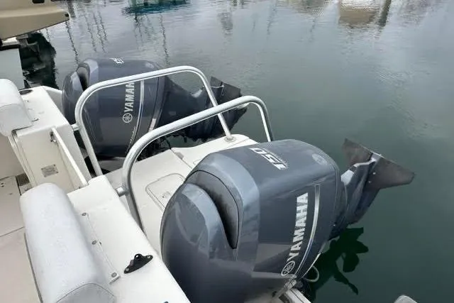 Slide: The Image of 2013 Glacier Bay 2680 Coastal Runner with dual Yamaha outboard motors in marina. - 3